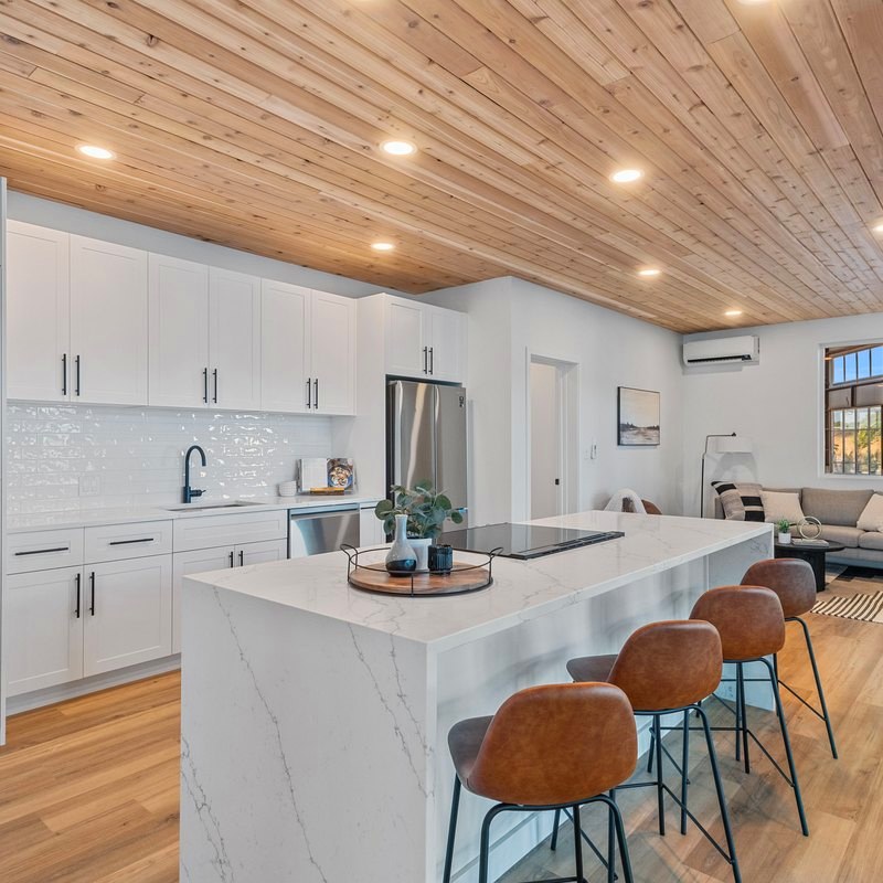Finished kitchen and living space with island seating